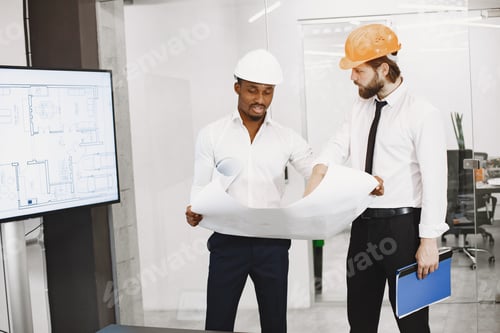 Preview: Two managers in the office with helmets