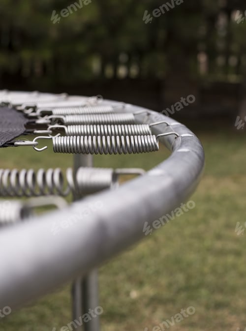 Preview: Vertical selective focus shot of a trampoline in the park