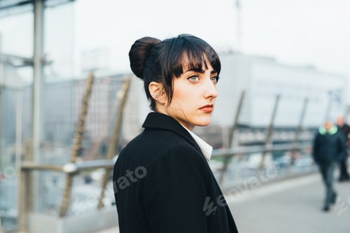 Preview: Businesswoman on pedestrian bridge, Milan, Italy