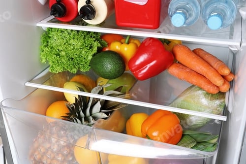 Preview: Open refrigerator with many different products, closeup