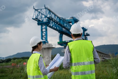 Preview: Civil engineers are measuring with surveying tools during the construction.