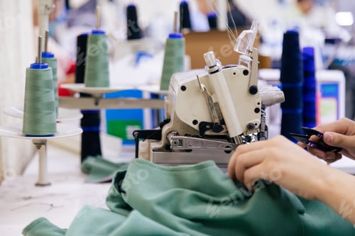 Preview: Tailor working on electric sewing machine