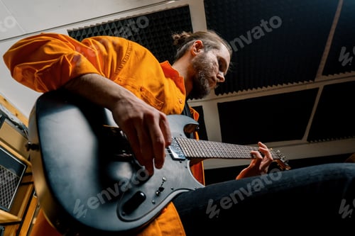 Preview: rock performer with electric guitar in recording studio recording playing track
