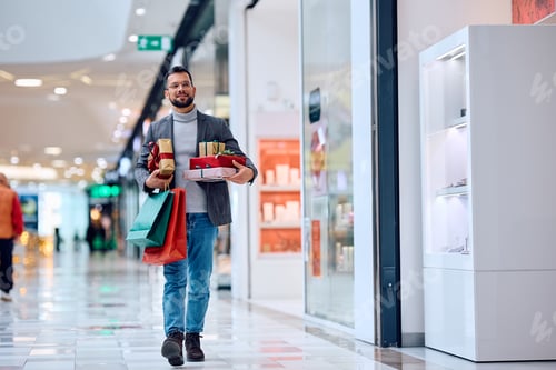 Preview: Young man spending a day in shopping at the mall.