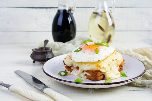 Preview: Delicious breakfast. Hot french toast with ham and bechamel sauce - croque madame