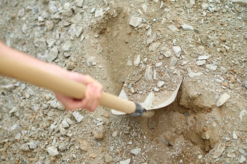 Preview: Hand of worker dripping gravel with shovel