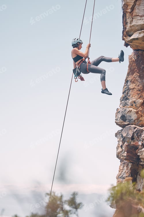 Preview: Woman climbing mountain with rope, outdoor nature activity and fitness exercise. Cliff rock climb,