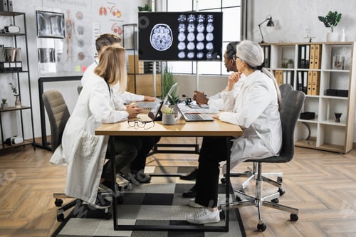 Preview: Group of doctors looking at screen with brain CT at hospital