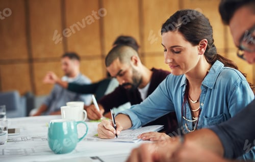Preview: The creative process. Shot of a group of colleagues working together at a table in an office.