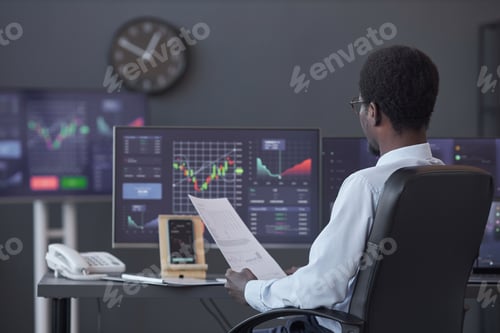 Preview: Trader analyzing financial market in office