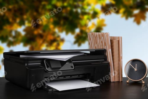 Preview: Compact home printer on desk with books against blurred background