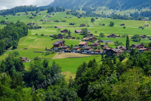 Preview: Charming Swiss Village with Traditional Chalets and Lush Hillside, Switzerland