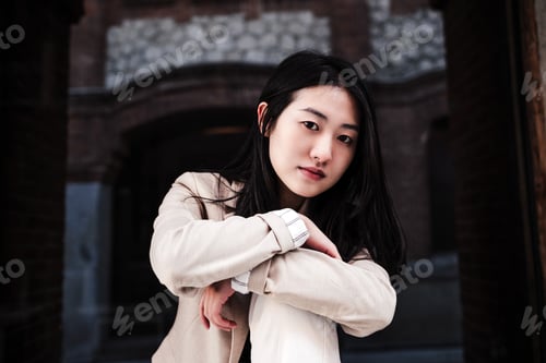 Preview: close up portrait of confident chinese woman in city leaning on wall