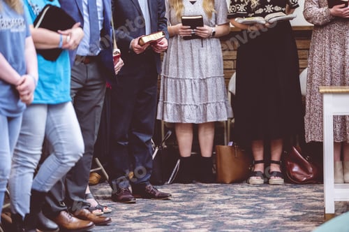 Preview: Group of people holding Bible books and praying during a congregation in a church