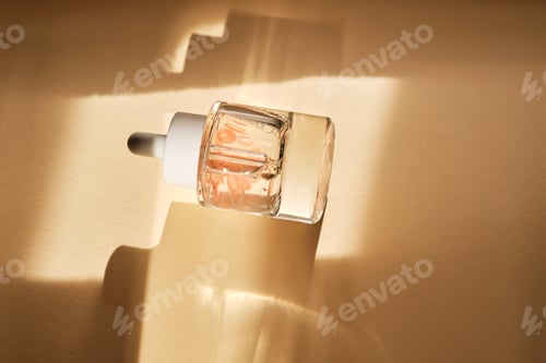Preview: A bottle of luxury serum with petals on a beige background.