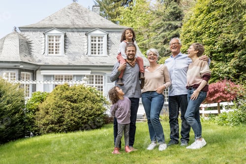 Preview: Happy extended family standing in garden of their home