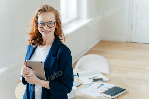 Preview: Prosperous female leader of working team holds digital tablet device, develops business ideas