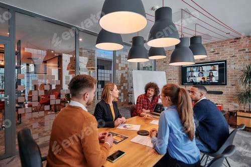 Preview: In the vibrant ambiance of a modern startup office, a diverse team of business professionals engage