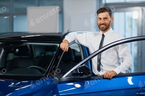 Preview: Smiling man in formal wear choosing new car at showroom