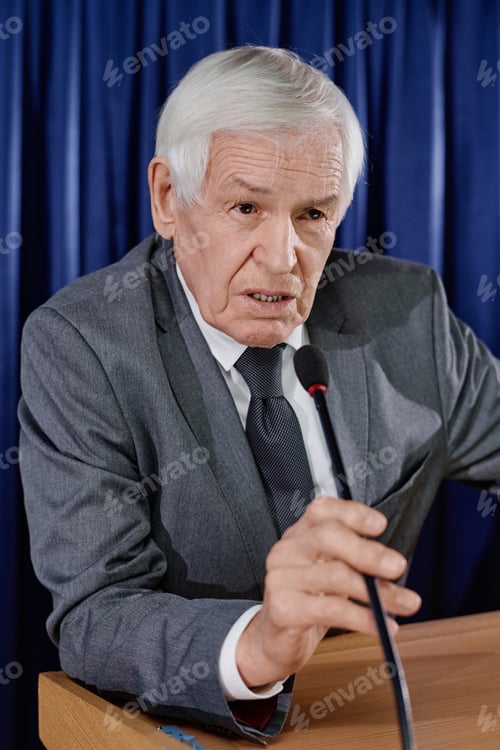 Preview: Businessman talking to journalists at conference