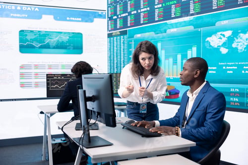 Preview: Diverse teammates examining statistics and infographics on computer