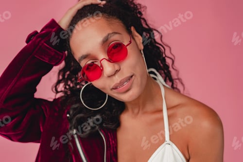 Preview: attractive black african american woman in stylish outfit on pink background