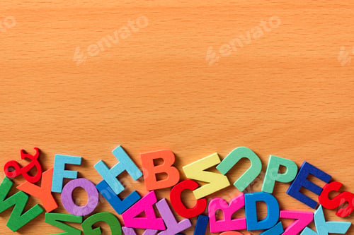 Preview: Colored alphabet letters on a wooden background. Copy space