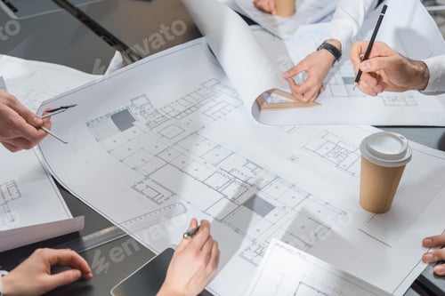 Preview: cropped shot of team of architects brainstorming on building plans
