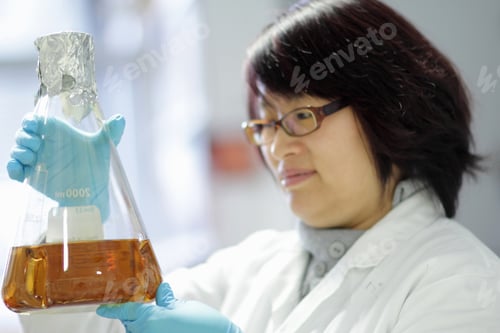 Preview: Scientist examining liquid in lab