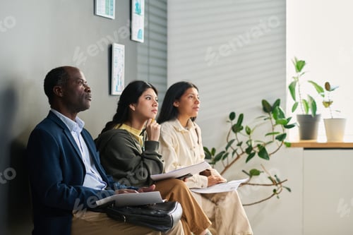 Preview: Multiethnic Adults Waiting for Interview at Visa Center Reception Area