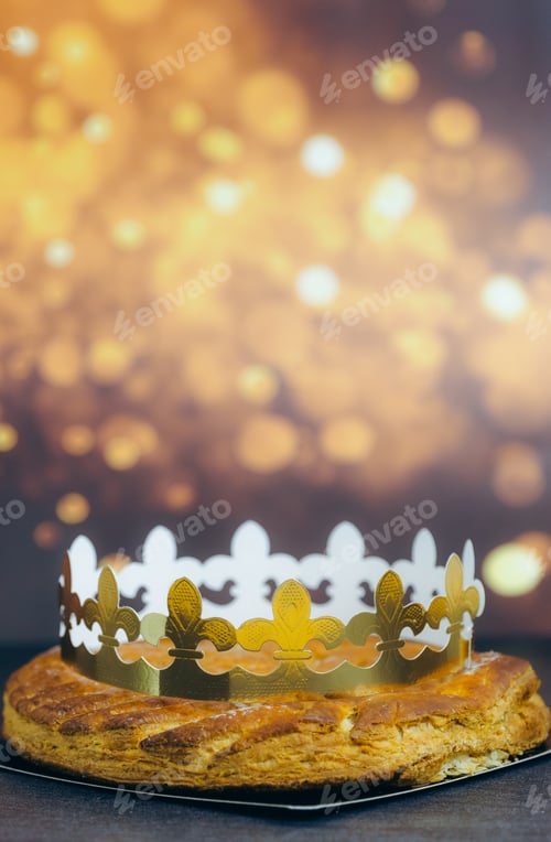 Preview: Fresh almond royal galette with crown on table with bokeh.
