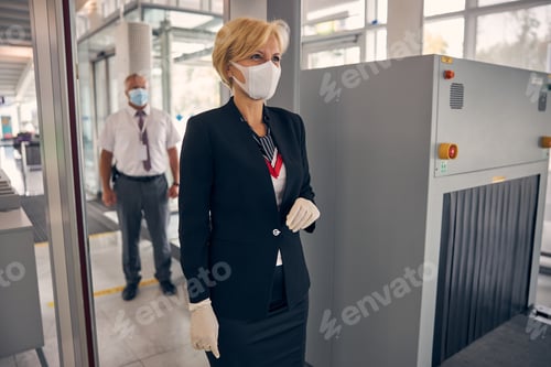 Preview: Charming woman walking through security control gate at airport