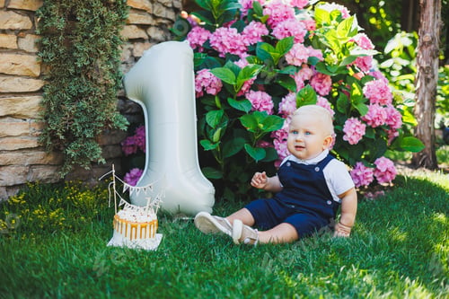 Preview: Boy's first birthday with an inflatable ball. A boy in a white polo shirt and overalls. Holiday