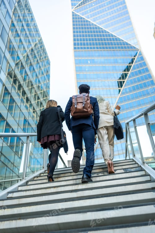 Preview: Business people colleagues walking up stairs in modern city