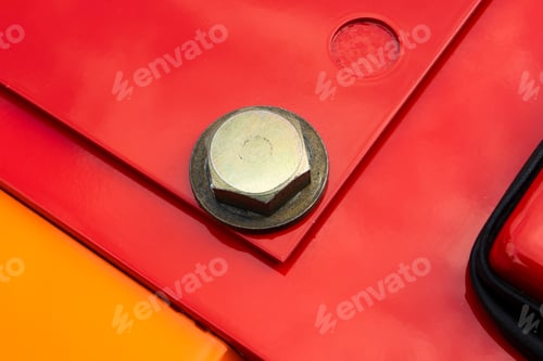 Preview: Close up of red and orange metal surface connected with steel bolts