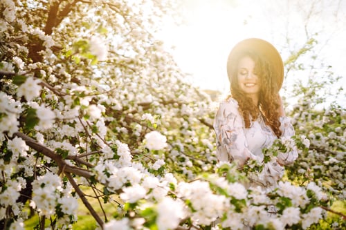 Preview: Smiling woman with hat in spring park. The concept of relax, travel, freedom.