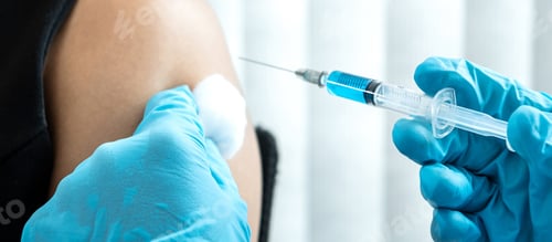 Preview: Doctor in medical glove holding syringe to injection coronavirus vaccine in the shoulder of patient