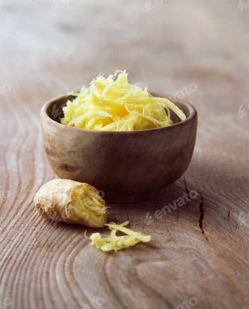 Preview: Fresh ginger root grated in wooden bowl