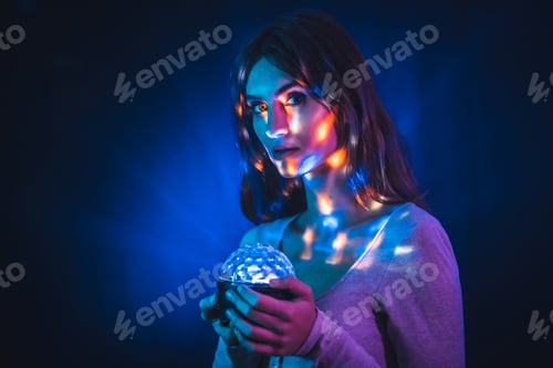 Preview: A young brunette Caucasian woman in a white t-shirt in a noghtclub