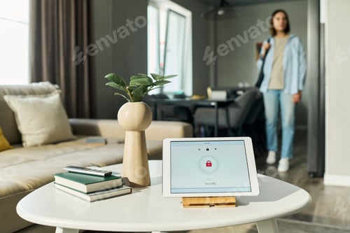 Preview: Caucasian Young Woman Entering Room While Smart Home Security System Monitoring