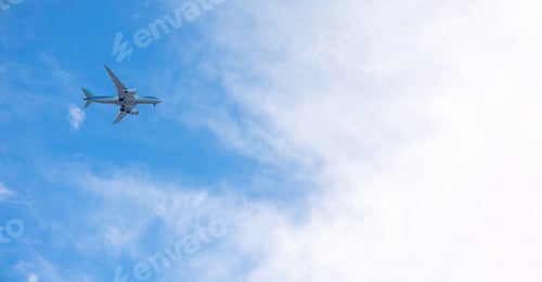 Preview: View of airplane flying in blue sky among white clouds. Banner, copy space
