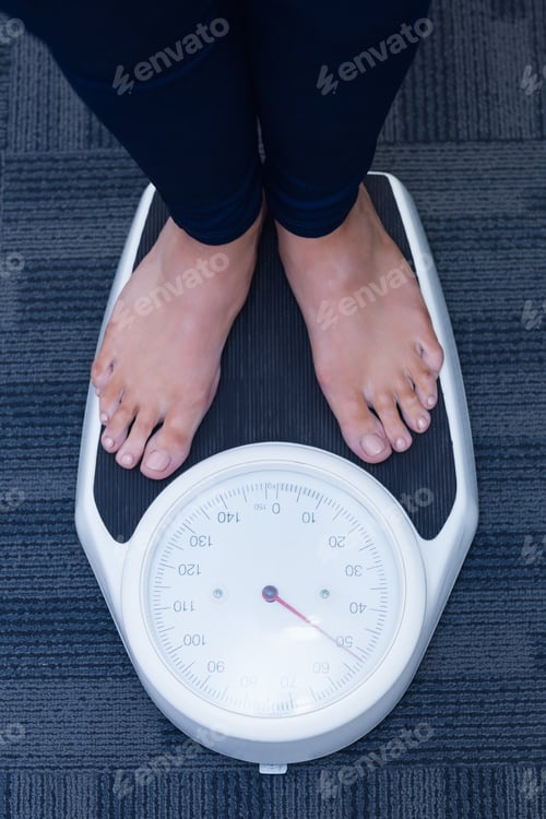 Preview: Close up of a woman standing on the scales in hospital