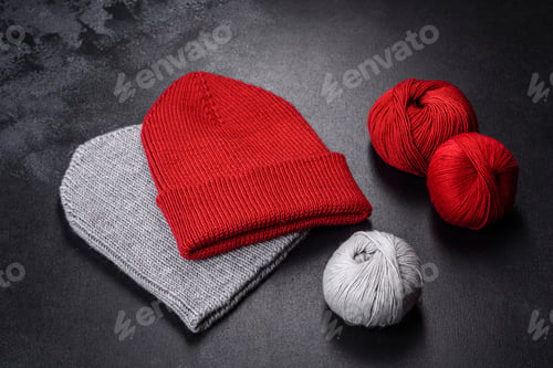 Preview: Red warm knitted women's hat on a concrete background