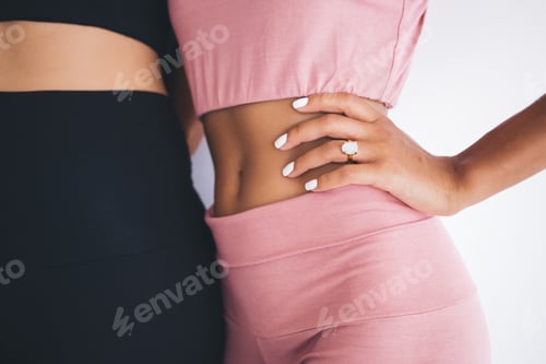 Two Women Wearing Crop Tops and Leggings