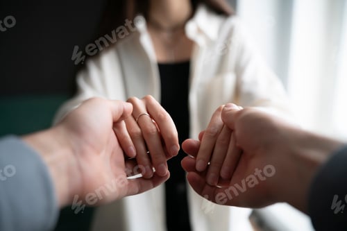 Preview: Gentle Male and Female Hands Offering Comfort and Support in a Time of Need