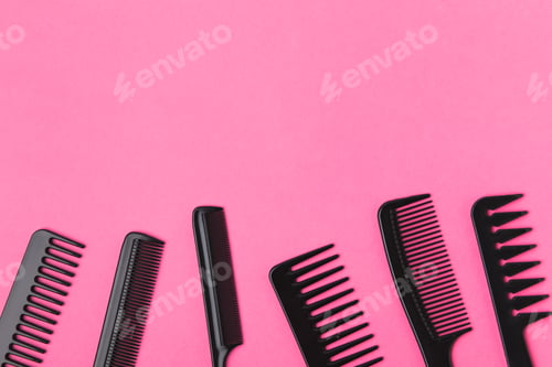 Preview: top view of black combs, isolated on pink