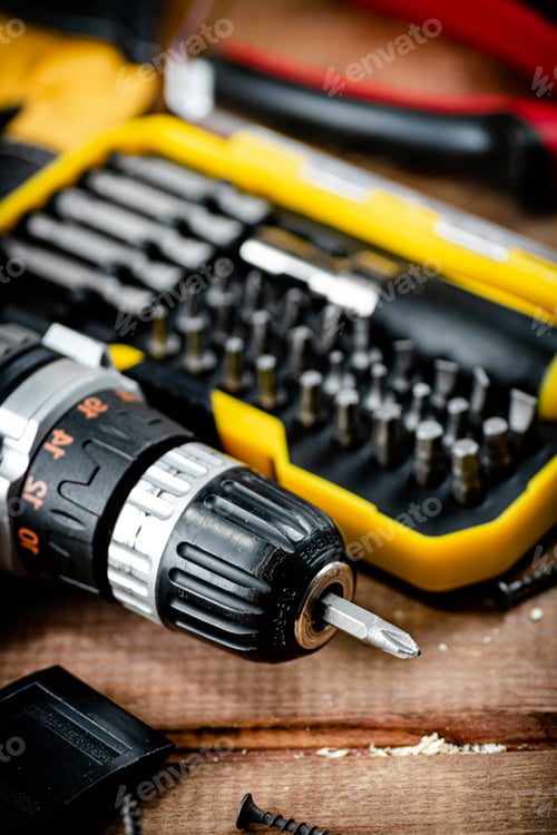 Preview: Working tool. Screwdriver with self-tapping screws on the table.