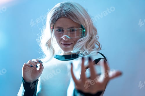 Preview: Woman with illuminated futuristic glasses and white hair, virtual reality with serious look