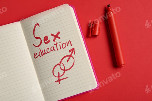 Preview: Notebook with phrase "SEX EDUCATION" on red background, flat lay