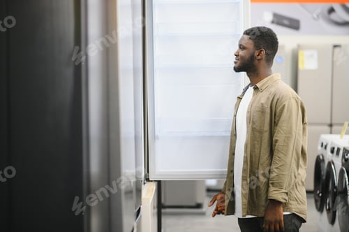 Preview: Man choosing fridge in the shop